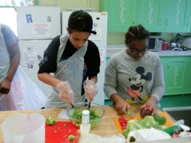 Two students making food in a kitchen