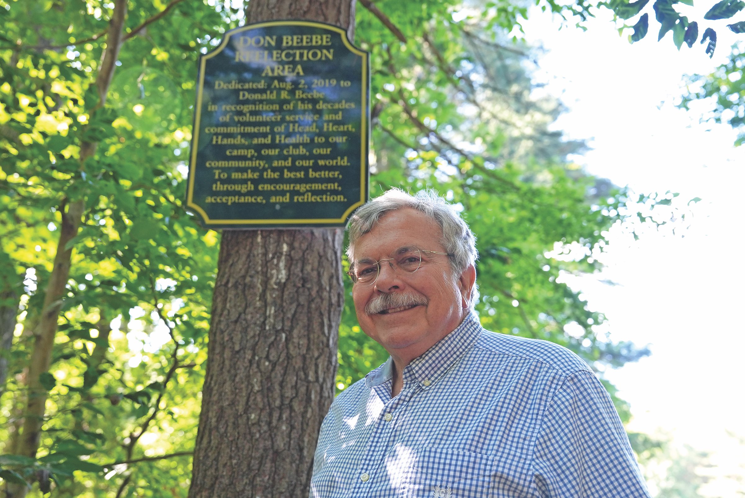 Don Beebe standing outside by a tree at the New London County 4-H Camp