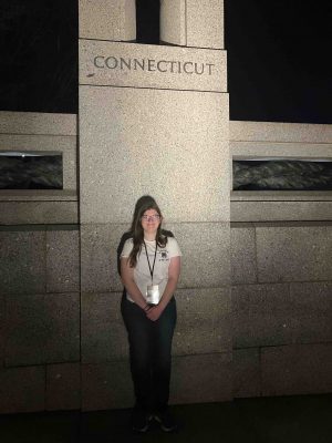 Fiona standing in front of a stone pillar that says Connecticut