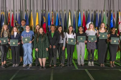 a group of 4-H members holding certificates