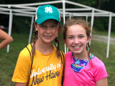 Two girls one wearing a 4-H hat