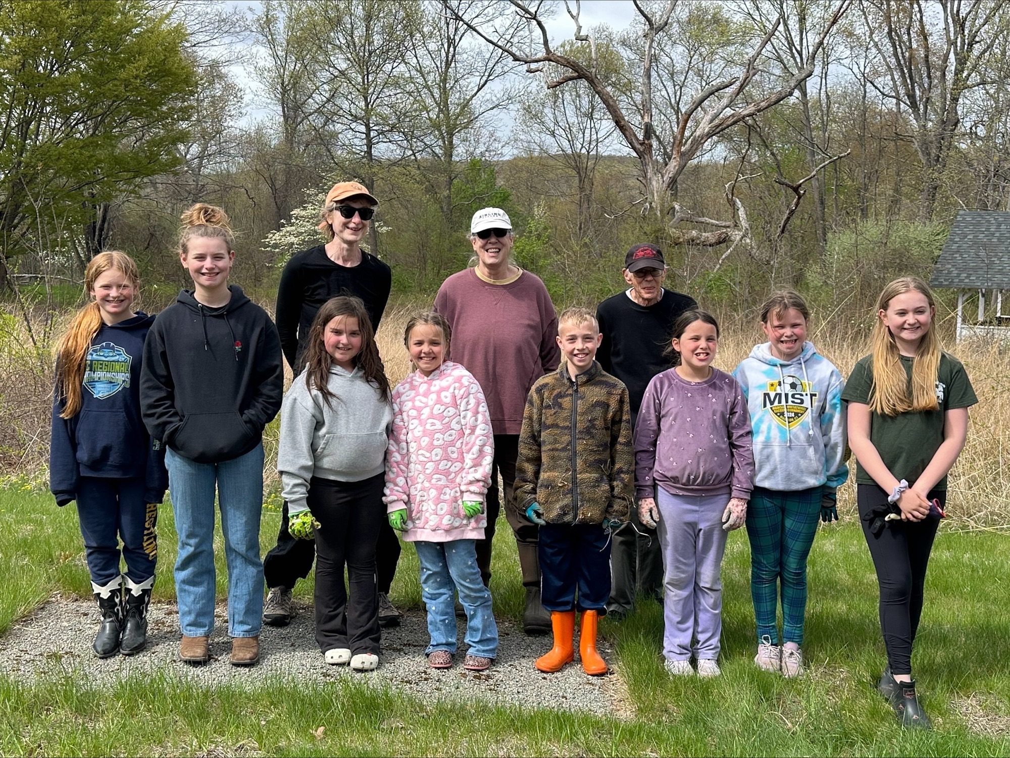 Photograph of 8 Middlesex County Mighty Minis 4-H Club members posing with 3 Middlesex County Master Gardeners outside.