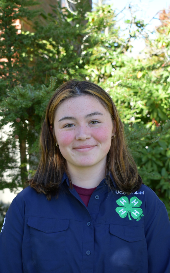 Girl wearing a blue shirt with a 4-H clover